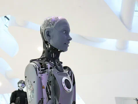 A humanoid robot with exposed joints standing in a bright exhibition hall